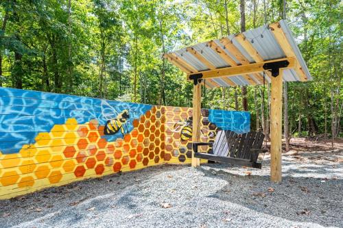 a playground with a painting on the wall at Elevate Tree House Community in Pittsboro