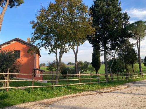 an orange house next to a fence at Azienda Agricola il Borgo di Sant'Elia in Castel SantʼElia