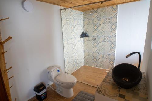 a bathroom with a toilet and a shower at Kavas Natural Connection in Salento