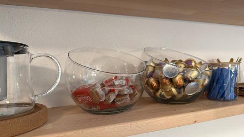 a shelf with two glass bowls filled with candy at Kalinkovo a whole new house close to X Bionic 10min in Kalinkovo