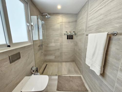 a bathroom with a shower with a toilet and a sink at 1BDR Rockstar's Paradise in front of Hard Rock H. in Punta Cana