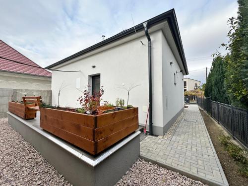 a garden on the side of a white house at Kalinkovo a whole new house close to X Bionic 10min in Kalinkovo