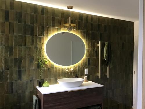 a bathroom with a sink and a mirror at Self contained and private room in Dunedin