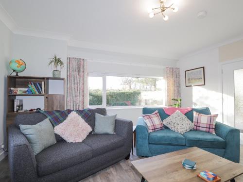 a living room with two couches and a table at Avemar in Buckie