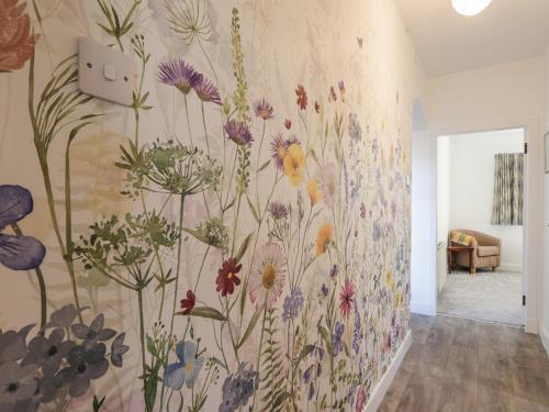 a mural of flowers on a wall in a room at Avemar in Buckie