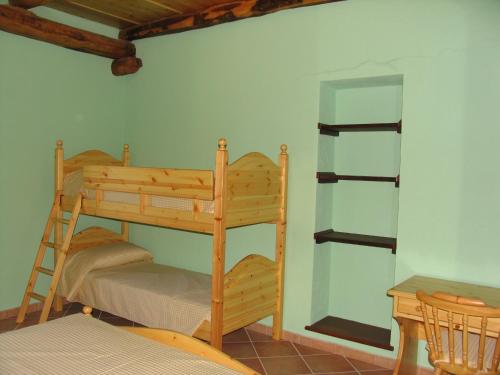 a bunk bed in a room with a ladder at Affitta Camere La Dolce Sosta in Perosa Argentina