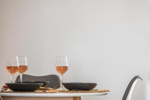 a table with two glasses of wine on it at Arch Chora Home next to the Old Castle in Naxos Chora