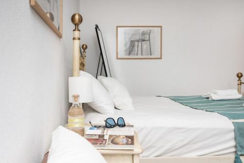 a bedroom with a bed and a side table with glasses at Marathitis cottage house - Aegean sea view in Kanakis