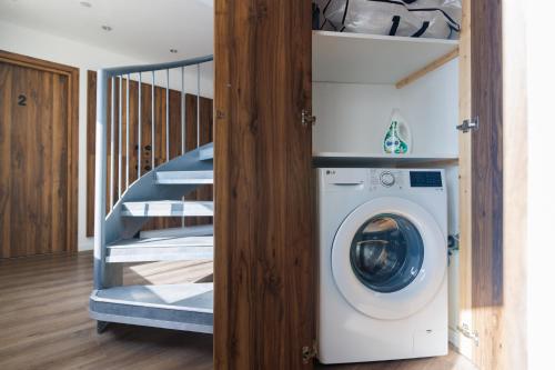 a washing machine in a room with a staircase at The Palm Suites - Adults Only in Limassol