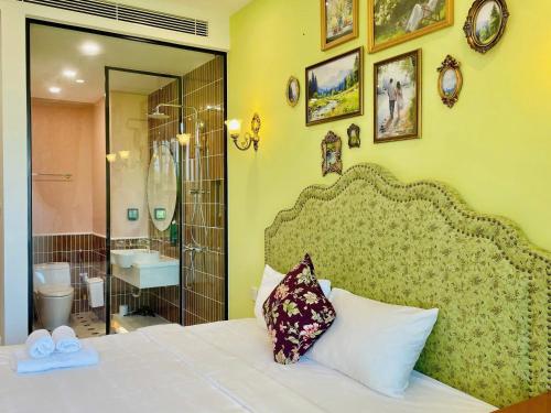 a bedroom with a bed and a bathroom at Sea Gallery Phu Quoc Luxury Apartment in Phu Quoc