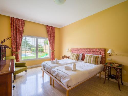 a bedroom with a large bed and a window at Golf Views Home By CanariasGetaway in Maspalomas