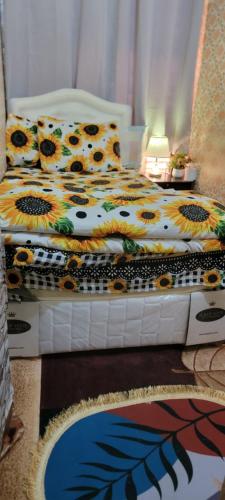 a bedroom with a bed with flowers on it at MAMA DELiGHT HOME in Abu Dhabi