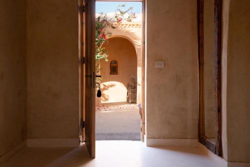 an open door to a room with a hallway at Tzila Lodge in Fayoum Center