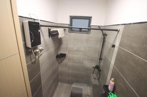 a bathroom with a shower with a sink and a toilet at Pristine Homes Studio Apartment - Mombasa Road in Nairobi