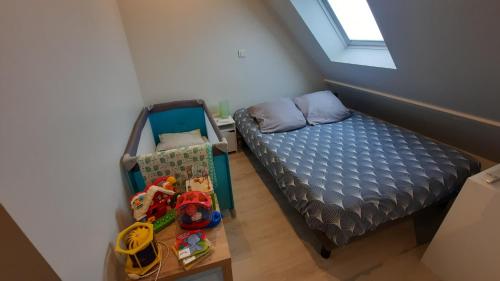 a small bedroom with a bed and a table with toys at Maison avec Parking, proche Tours in Vouvray