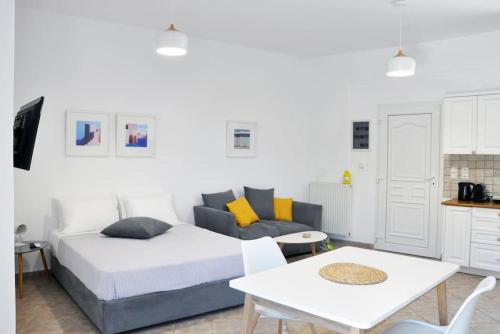 a bedroom with a bed and a table at Mary & Jo's Studios in Naxos Chora
