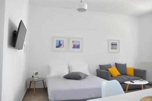 a living room with a bed and a couch at Mary & Jo's Studios in Naxos Chora