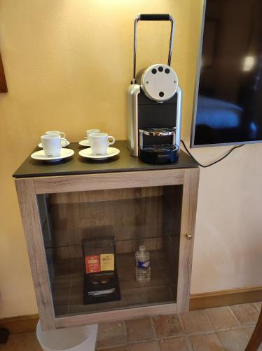 a table with two cups and a coffee maker on it at Hostellerie Les Hauts De Sainte Maure in Sainte-Maure-de-Touraine