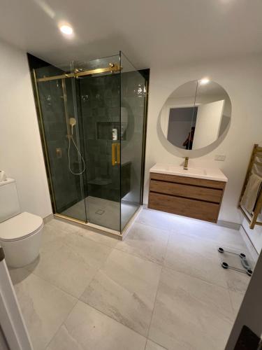 a bathroom with a shower and a toilet and a sink at Auckland Central City Oasis in Auckland