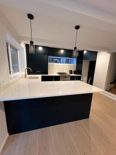 a kitchen with a white counter top in a room at Auckland Central City Oasis in Auckland