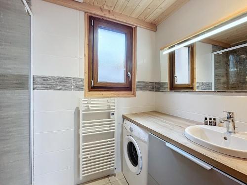 a bathroom with a washing machine and a sink at Chalet 6 pers, WiFi, parking, proche pistes - FR-1-267-297 in Villarembert