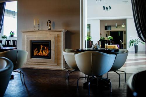 a living room with chairs and a fireplace at Vanilla House in Zwoleń