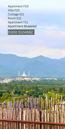 a view of a city from behind a wooden fence at LUXURY family cottage in Islamabad