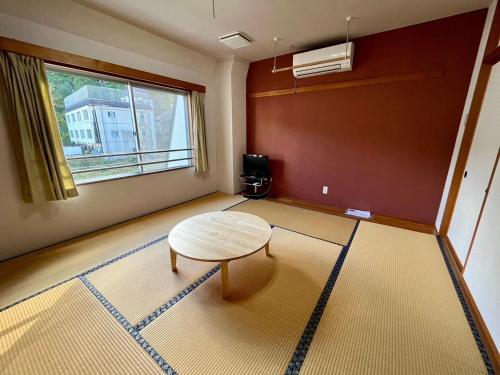 a living room with a table and a window at Yuzawa house 2 - Vacation STAY 39927v in Yuzawa