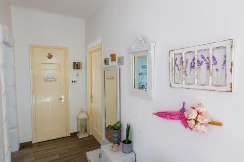 a room with white walls and a flower on the wall at Holiday Home Inga with free private parking in Rijeka