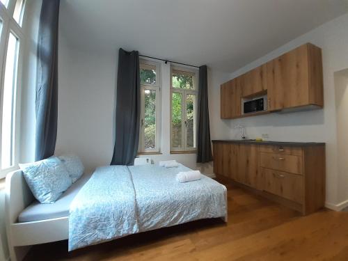 a bedroom with a bed and a cabinet and a window at Studio near to the City Centre in Luxembourg