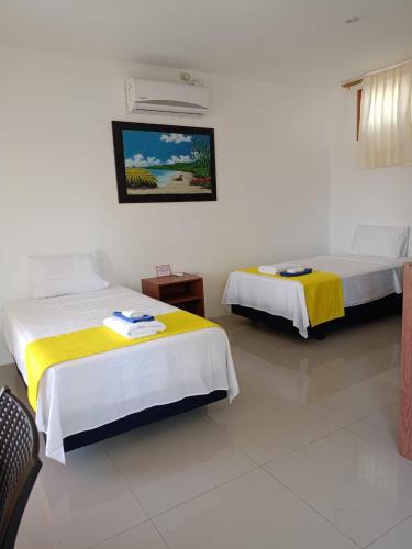 Postel nebo postele na pokoji v ubytování Galápagos Isabela Hotel Loja