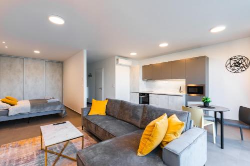 a living room with a couch and a kitchen at Lion PARKK Apartments in Kníničky
