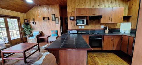 a kitchen with wooden cabinets and a counter top at Casa Bella Ntsuty 21 in Ponta do Ouro