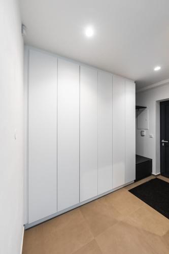 a room with white wardrobes at Lion PARKK Apartments in Kníničky