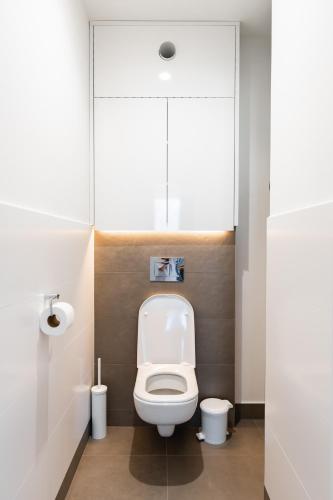 a bathroom with a white toilet in a stall at Lion PARKK Apartments in Kníničky