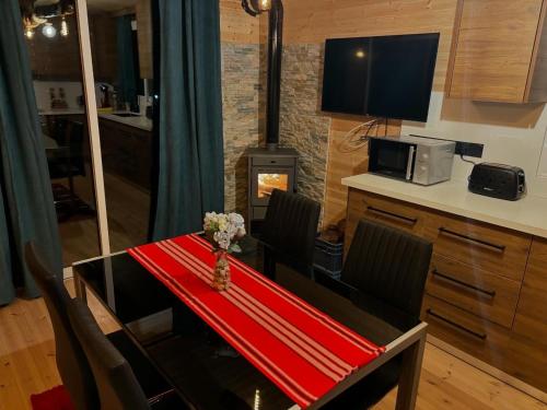 a dining room with a table and a stove at SOFROS VALLEY HILLS CHALET in Ayios Mamas