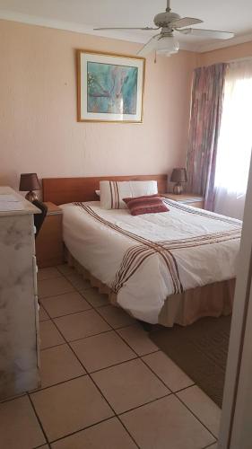 a bedroom with a large bed in a room at Jolly Suites in Midrand