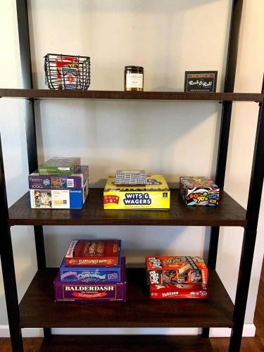 a shelf with snacks and other items on it at Rose District Willow House By Tulsa Getaways in Broken Arrow