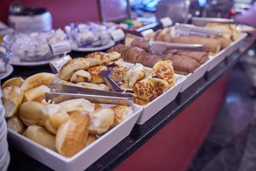 a display of different types of donuts on a counter at South American Copacabana Hotel in Rio de Janeiro