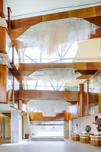 a large lobby with a large wooden ceiling at Sparkling Hill Resort and Spa - Adults-Only Resort in Vernon