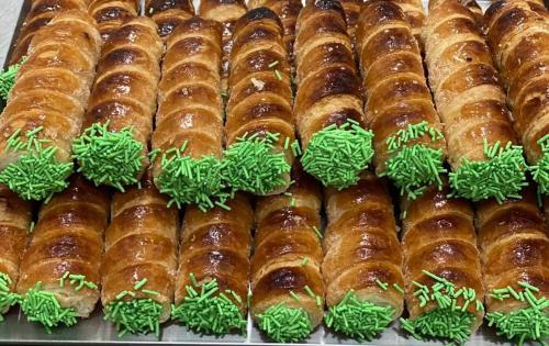 a display of donuts with green sprinkles on them at Jungle Sunshine Apartment in Alessandria