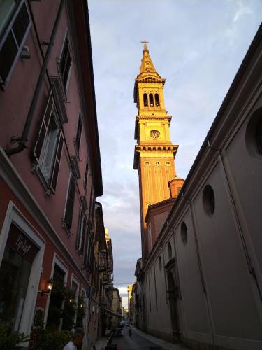 a tall clock tower with a clock on it at Jungle Sunshine Apartment in Alessandria