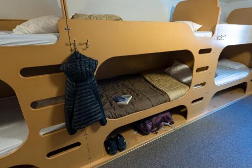 a bunk bed with two beds in a room at HI Castle Mountain - Hostel in Castle Junction