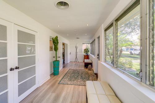 a hallway with a couch and a window at 5 Mi to Vero Beach Vintage Home with Sauna and Grill! in Vero Beach