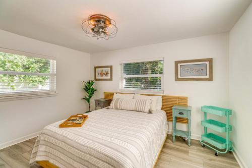 a bedroom with a bed and a blue table at 5 Mi to Vero Beach Vintage Home with Sauna and Grill! in Vero Beach