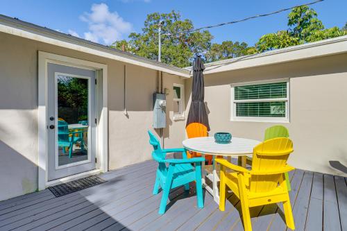 a deck with a table and chairs and an umbrella at 5 Mi to Vero Beach Vintage Home with Sauna and Grill! in Vero Beach