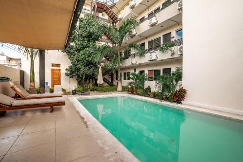 a swimming pool in the middle of a building at Guitarra Inn in Puerto Escondido