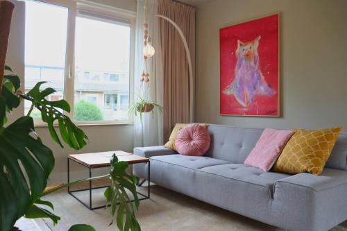 a living room with a couch and a painting of a dog at Casa Galia Apartments in Nijmegen