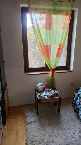 a room with a table in front of a window at Vila Seoska idila in Izvor