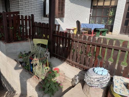 a wooden fence with some plants in a yard at Vila Seoska idila in Izvor